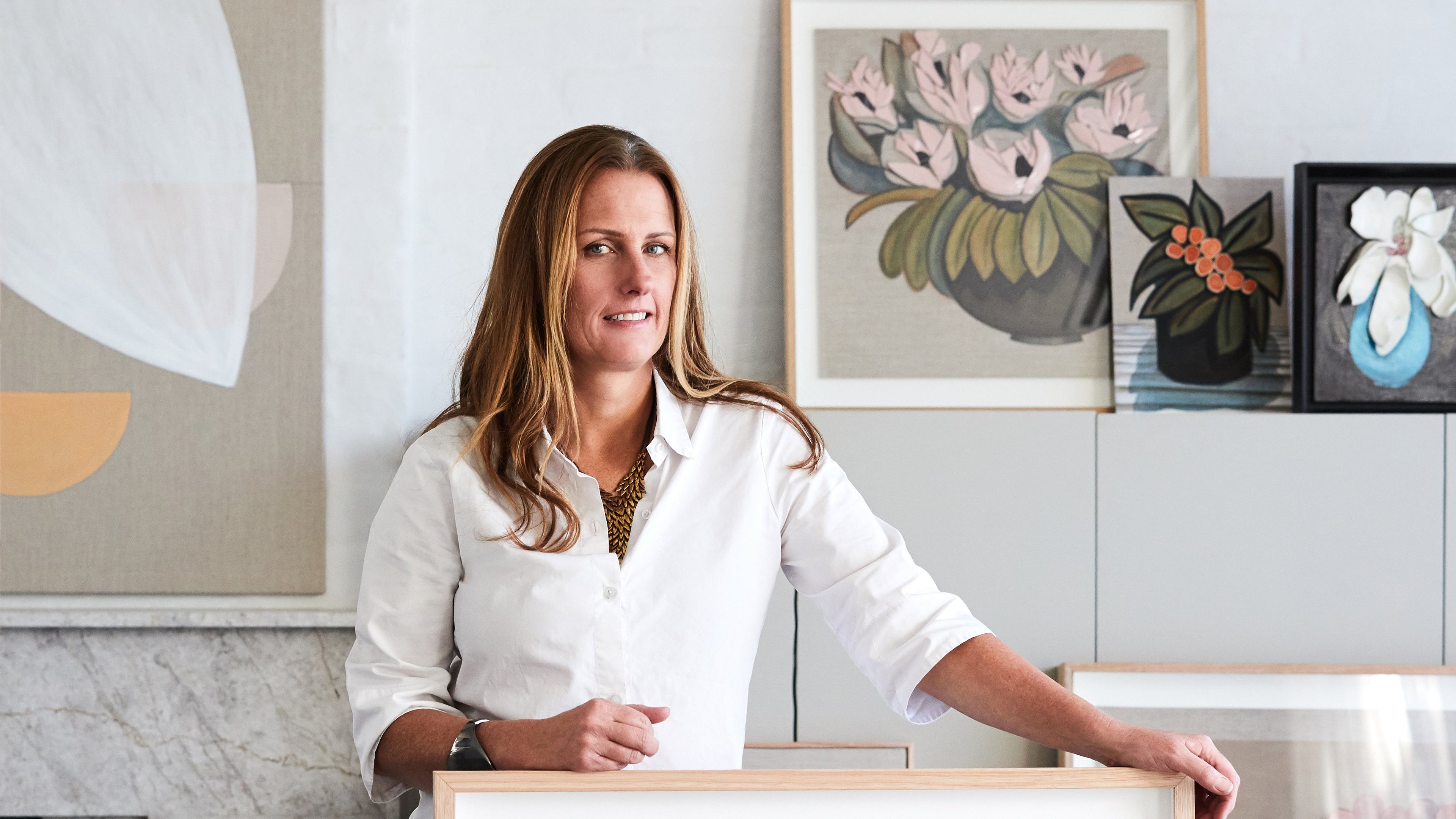 Artist Tory Burke in her studio with her original artwork